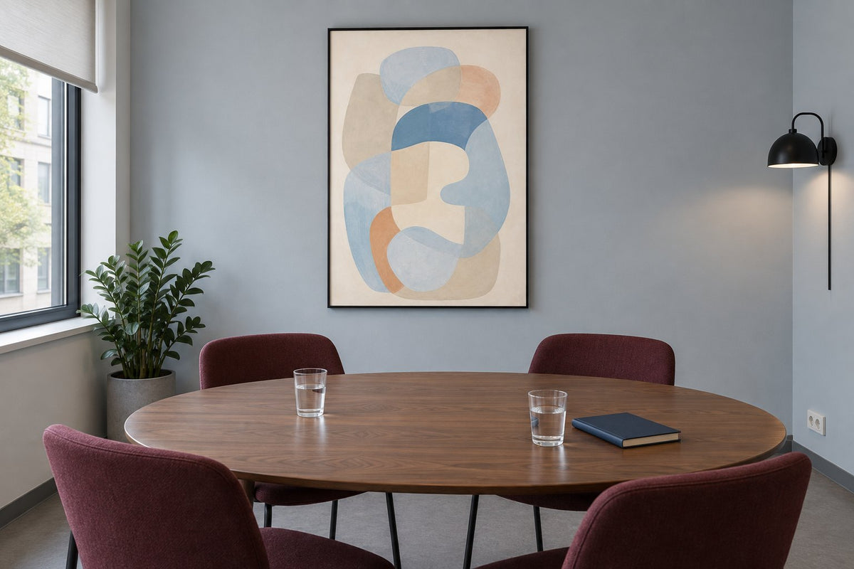Abstract blue-shape print in a meeting room with a blue-grey wall, walnut table and burgundy chairs
